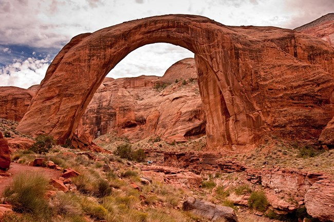 Natural sandstone arch in an uneven canyon