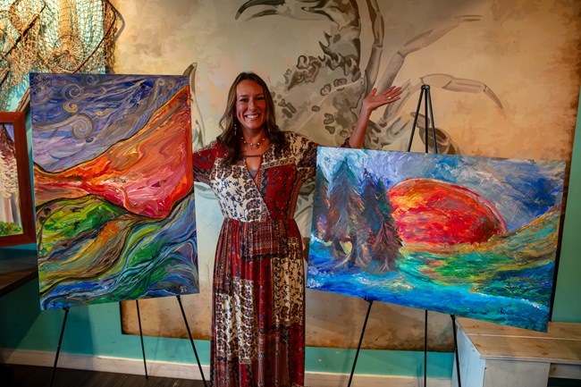 Alicia Wilson with two of her paintings