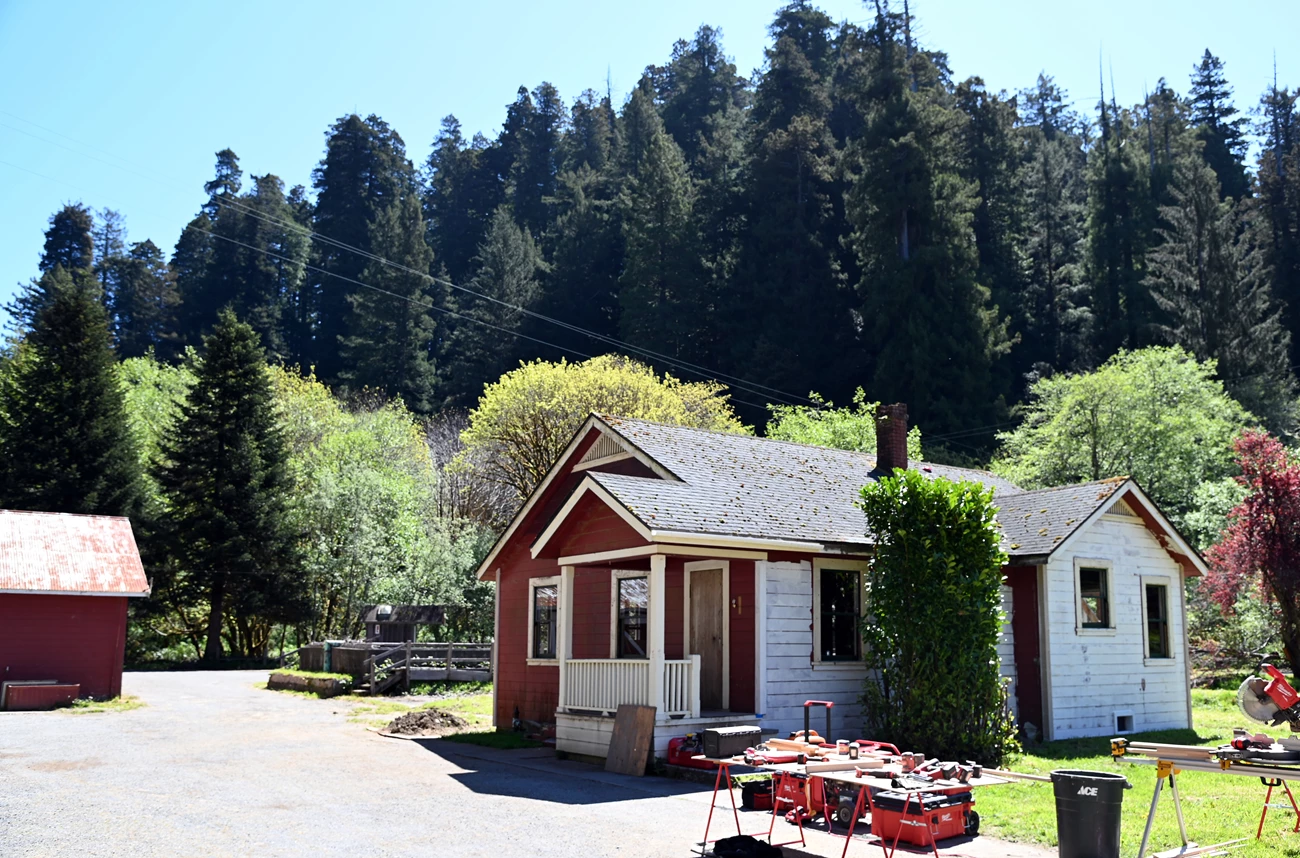 The Hatchery Repair Project 2024 A single story building being worked on. Trees surround the area.