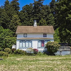 A white wooden 2-story building from the 19th century.