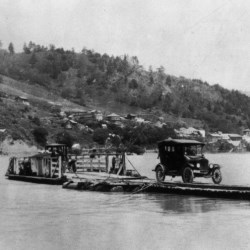 Old car on raft in river