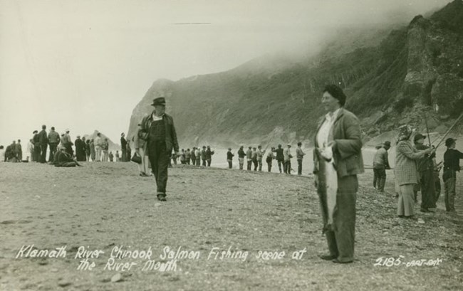 Black and white photo of people fishing in early 1900s