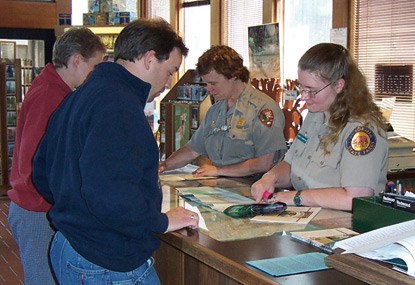National Park Service and California State Parks staff with visitors at Crescent City Information Center.