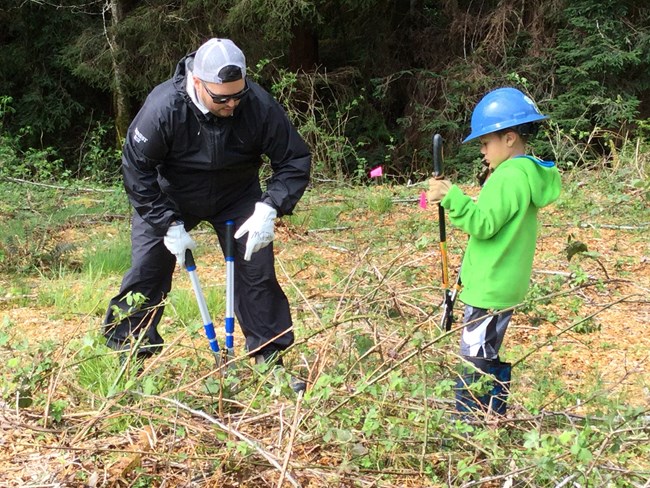 Father and young son use handtools