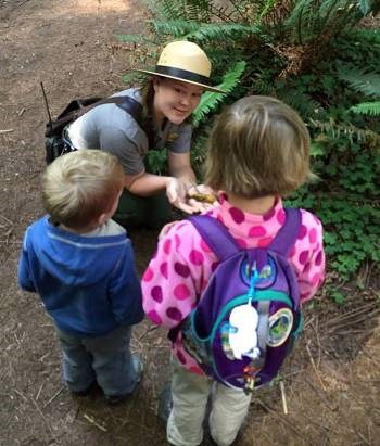 A ranger talks to children