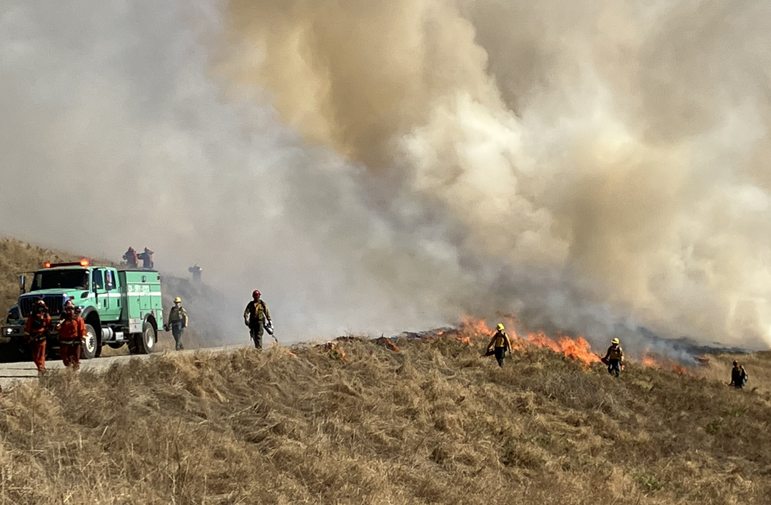 Bald Hills Prescribed Burn Prescribed Burn on Bald Hills in Redwood National Park. The sky is filled with smoke and there is a fire truck and crew conducting the burns.