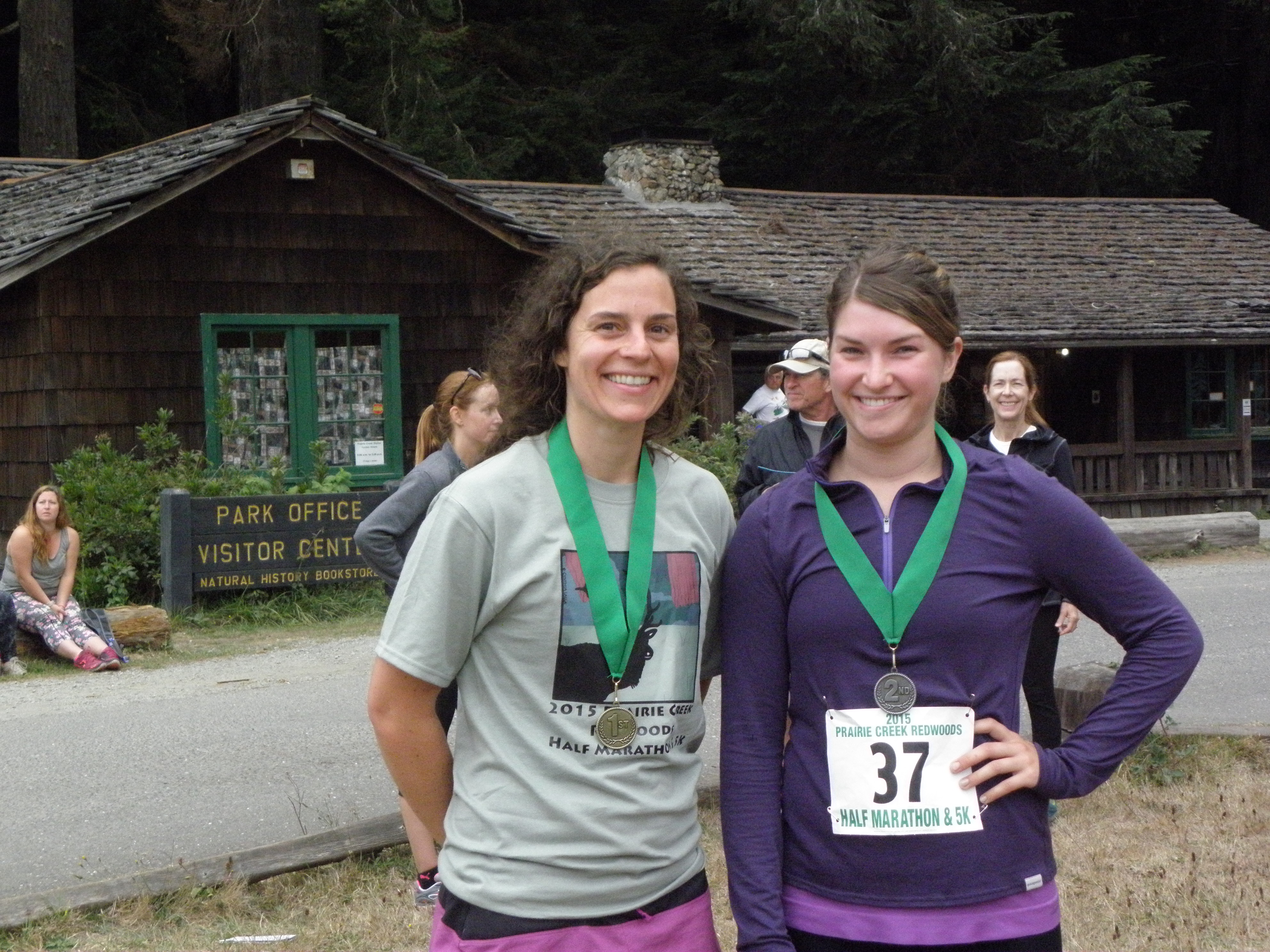 Two runners wear their medals.