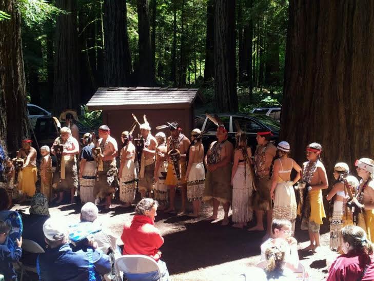 Tolowa dancers perform in front of a crowd