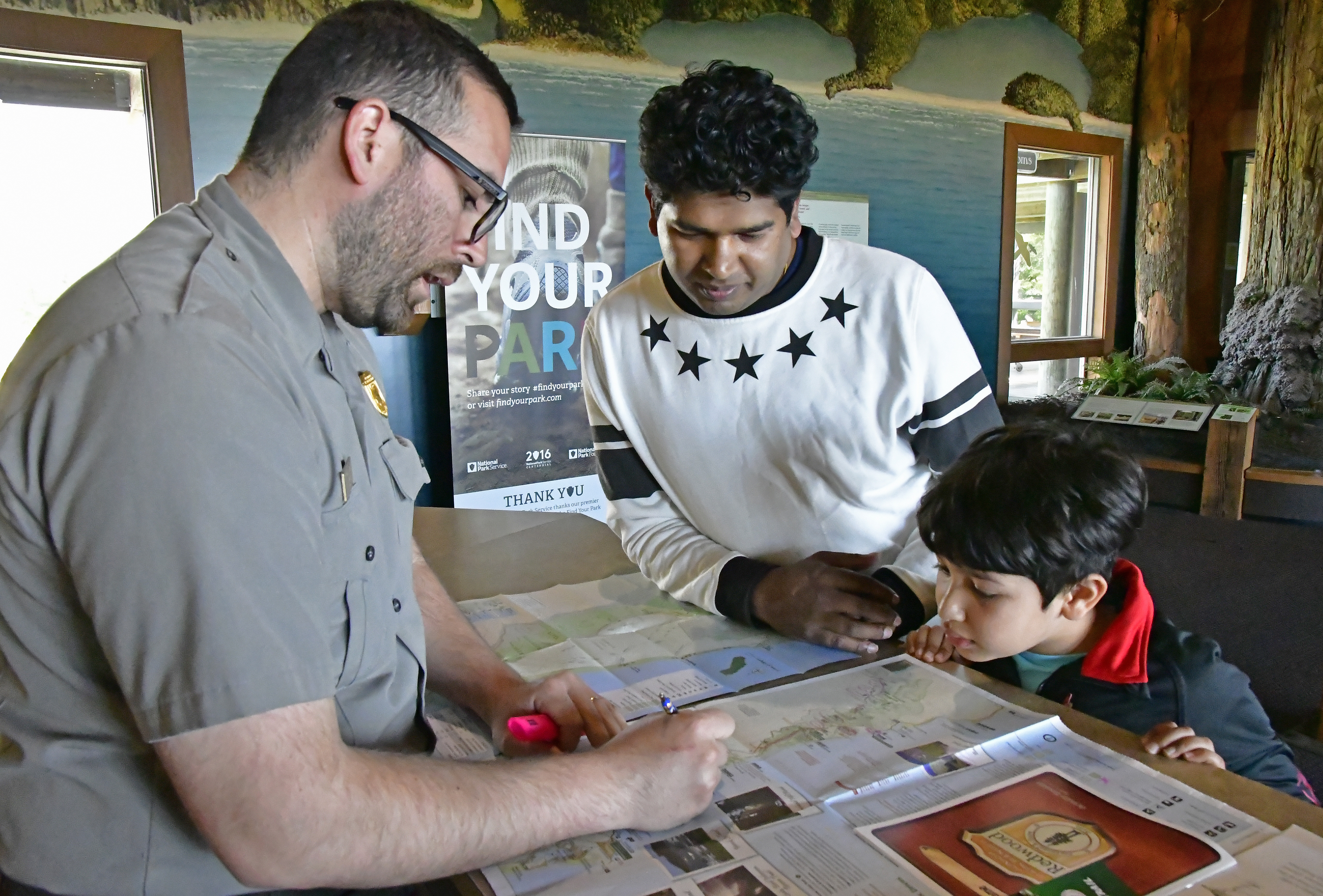 Father, son talk with a park ranger