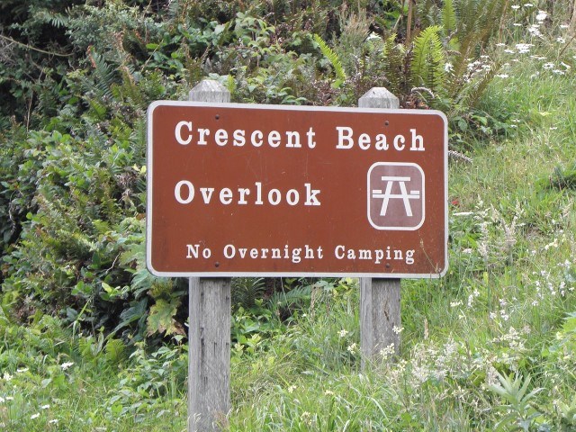 image of a sign with vegetation in the background