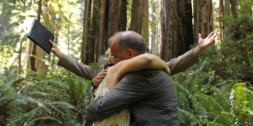 A newly married couple embrace.