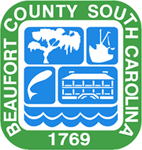 "Beaufort County, South Carolina, 1769" in a square around a shield of an oak tree, shrimp boat, fish, historic building, and waves.