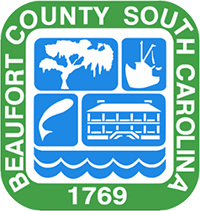 Beaufort County Logo "Beaufort County, South Carolina, 1769" in a square around a shield of an oak tree, shrimp boat, fish, historic building, and waves.