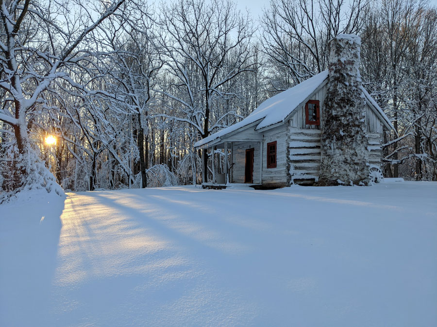 Gilmore-House-at-Winter A historic cabin in a snowy winter sunset