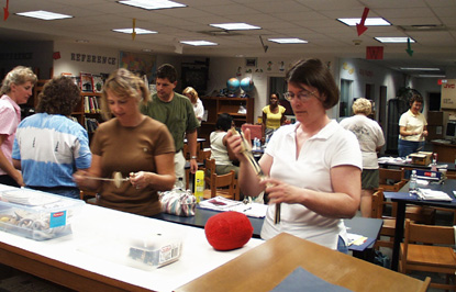 Teachers learn about 19th century games during a workshop.