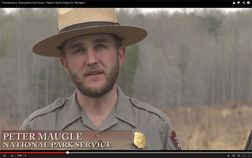 ranger in an open field with a treeline in the background