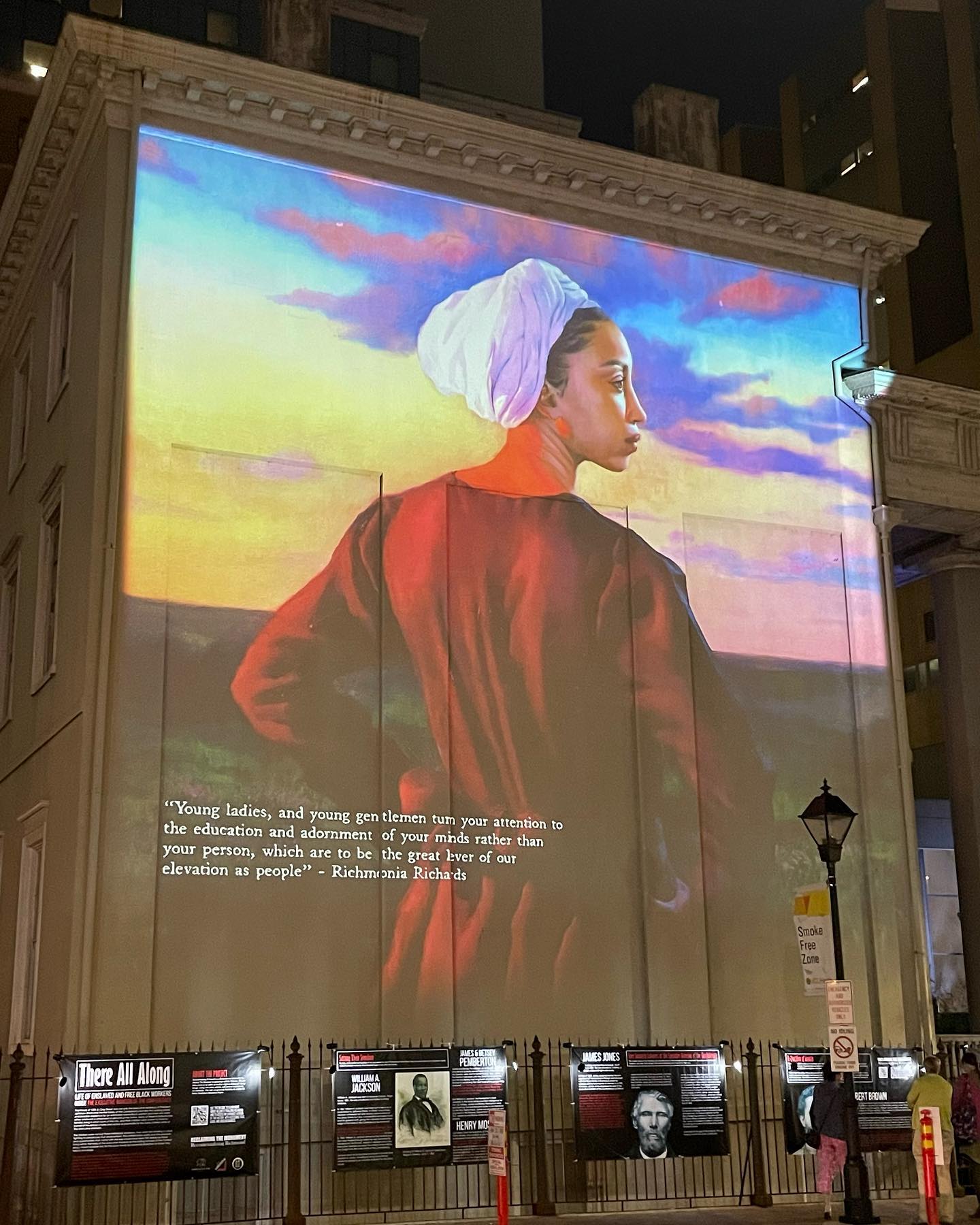 An African American woman in 19th-century clothing standing outdoors.