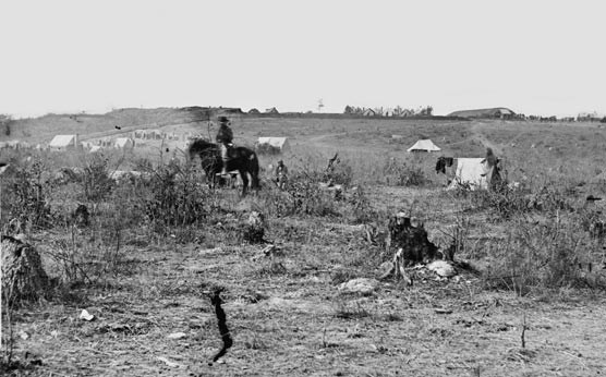 Civil War image.  Fort Harrison is in the distance, a man on horseback is in the foreground.