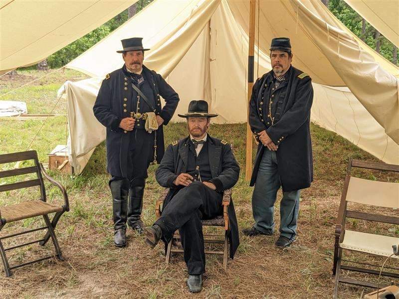 Grant and staff at Cold Harbor Battlefield. Reenactors dressed as General Ulysses Grant and his staff in front of a canvas tent.