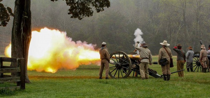 Living history demonstrators firing a cannon
