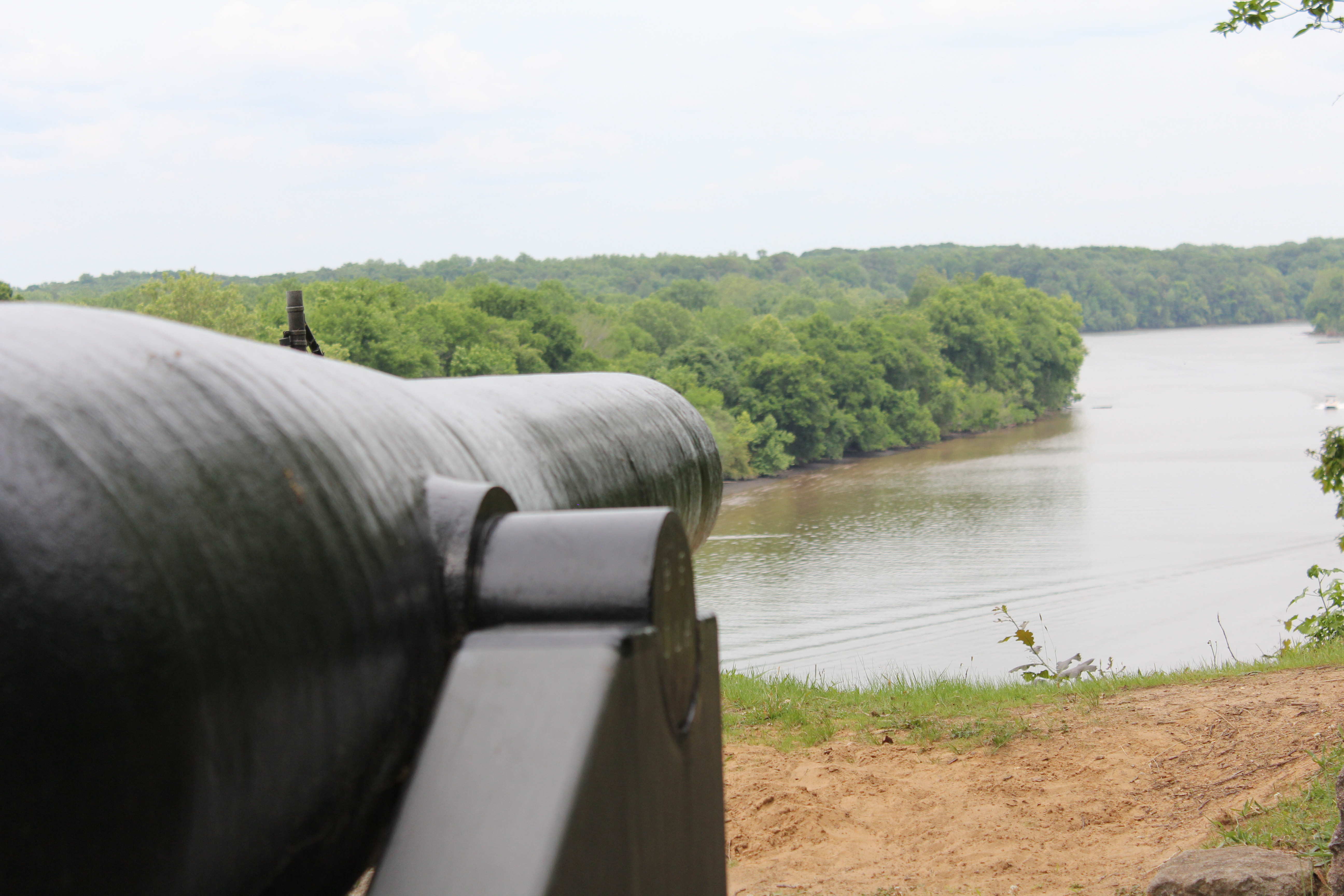 James River Defenses A large iron cannon overlooks a bend in the river.