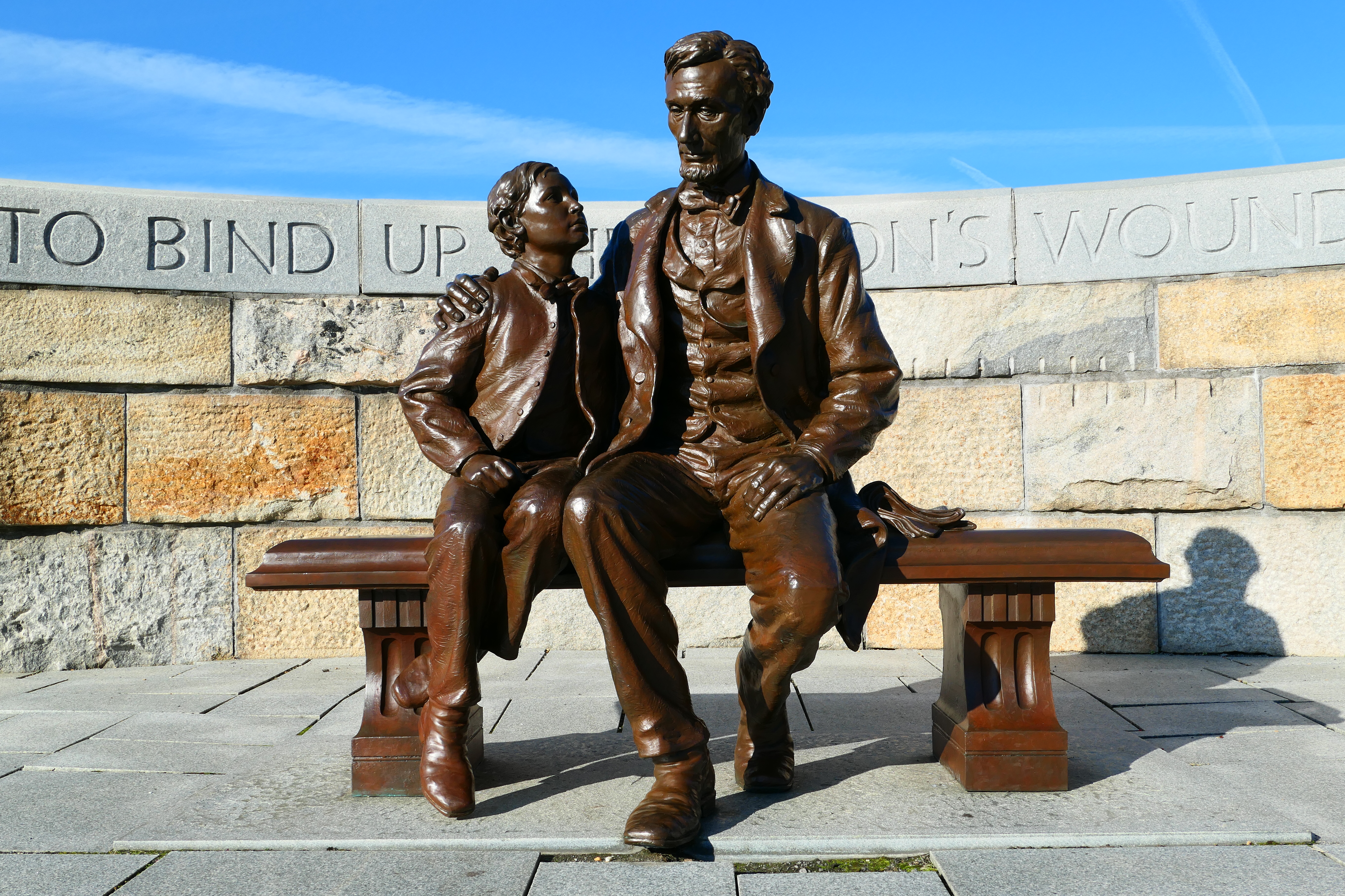 A bronze statue depicts Abraham Lincoln seated beside his 12 year-old son, Tad.