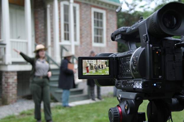 Filming at Richmond National Battlefield Park A park ranger, speaking, is visible in the viewfinder screen of a digital movie camera on a tripod