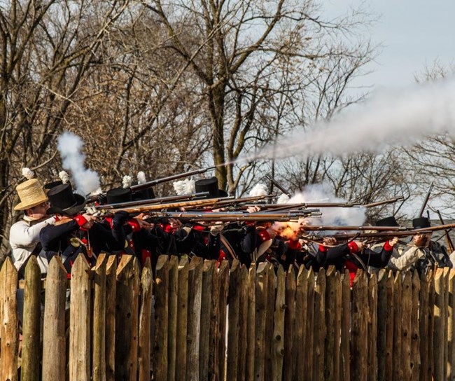 Soldiers firing behind the fences of Frenchtown