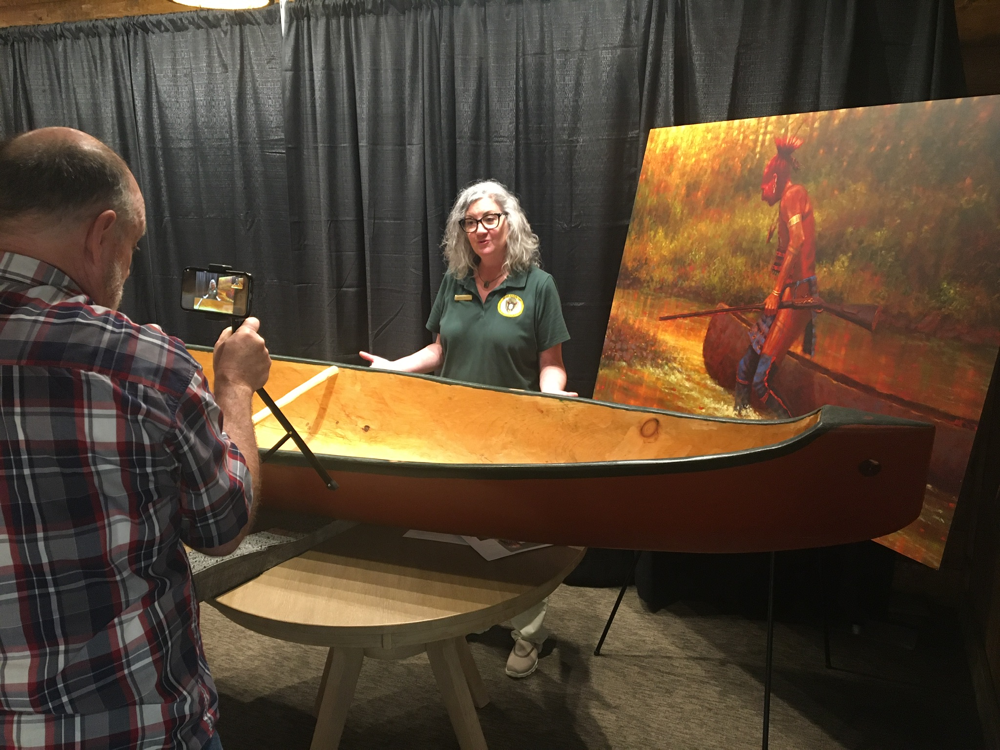 Interpreter showing a canoe