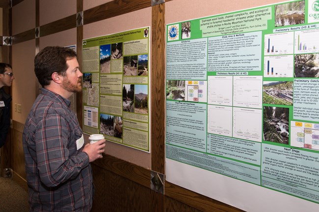 A man reads a scientific poster.