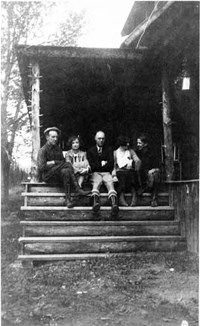 McGraw family members sit on the main house front porch.