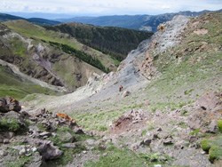 Researchers walk in the alpine tundra.