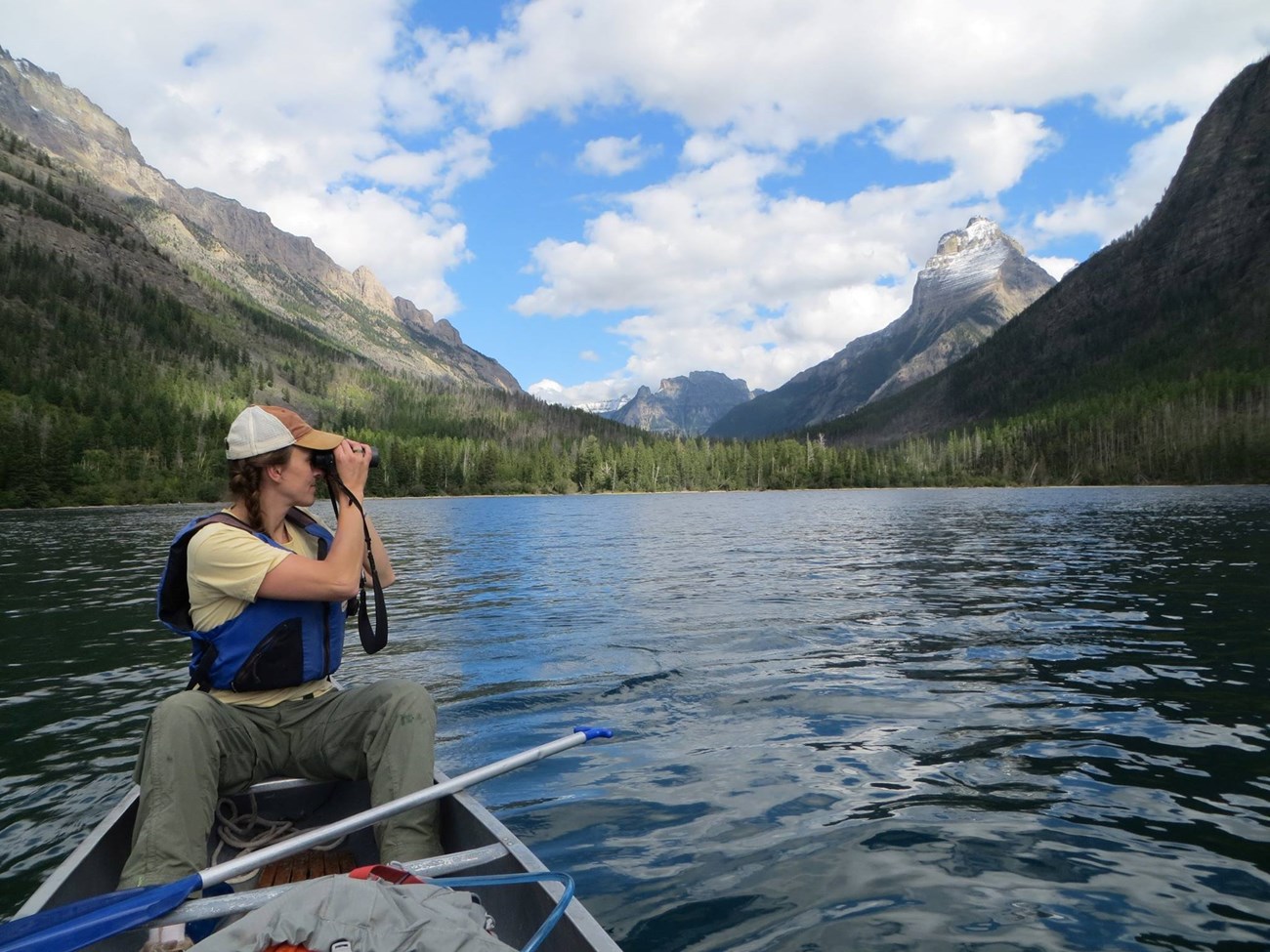 Citizen scientist sits in a canoe and scans for loons.