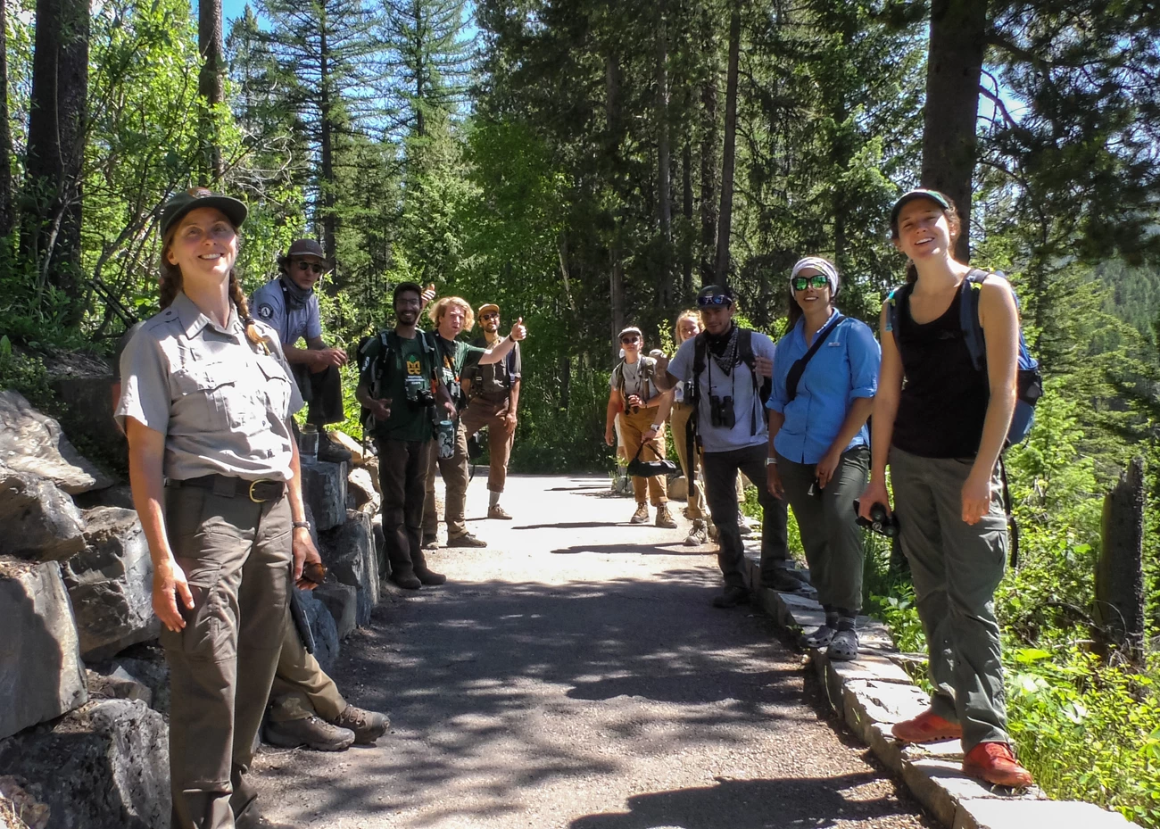 MCC crew and park staff pose for the camera MCC crew and park staff stand lined up on a paved path.