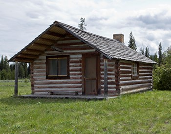 McCarthy Cabin Restored log cabin with pitched roof and small porch