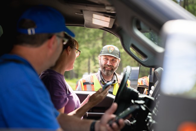 Ticketed Entry Contact Park ranger talks to visitors through a car window.
