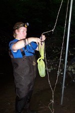 A researcher prepares a mist net to capture and study bats on a dark night in northwest Indiana.