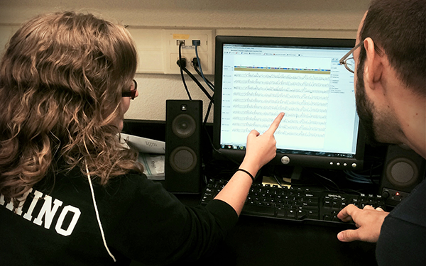 Career Pathways Two students look at a spreadsheet on a computer screen.