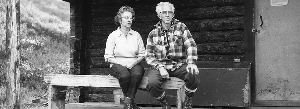 black and white photo of a man and woman sitting on a porch black and white photo of a man and woman sitting on a porch