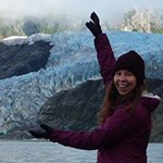 A girl sizes up a glacier using her hands A girl sizes up a glacier using her hands