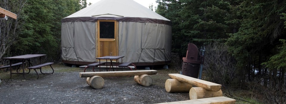 a yurt surrounded by benches and picnic tables