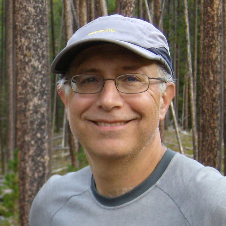 Headshot of Steve Acker, a smiling white man with white hair, glasses, and a ball cap.