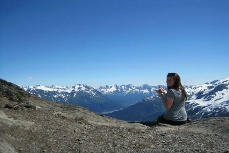 lt= girl sitting in the mountains
