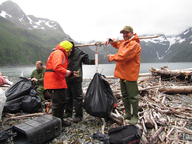 National Park staff weigh bags of trash collected from beach