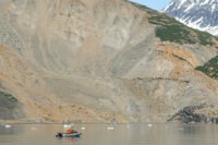 observing landslide alt="Scientists observe area of landslide from a skiff in Taan Fjord"
