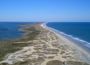 lt= Great Island cabins close to the shoreline on the South Core Banks of Cape Lookout