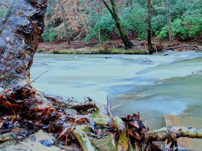lt= The Chattahoochee River flows past the muddy river banks