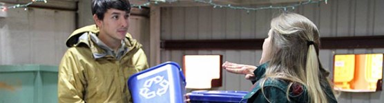 A park staff member teaches a volunteer more about recycling programs