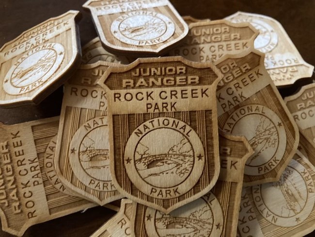 A pile of wooden Rock Creek Park junior ranger badges