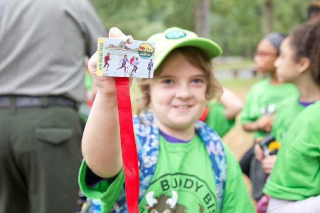 A fourth grade student shows off her Every Kid in a Park badge! A young girl shows off her Every Kid in a Park badge during an event.